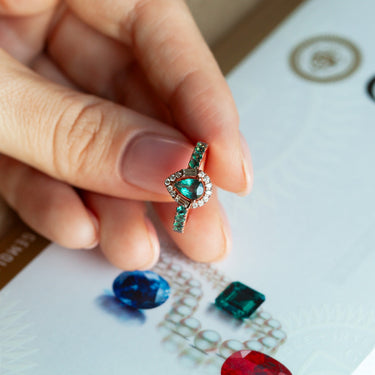 0.52ct natural alexandrite pear-shaped ring with diamonds in 18k rose gold held in hand